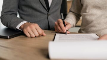 A Person Signing a Contract