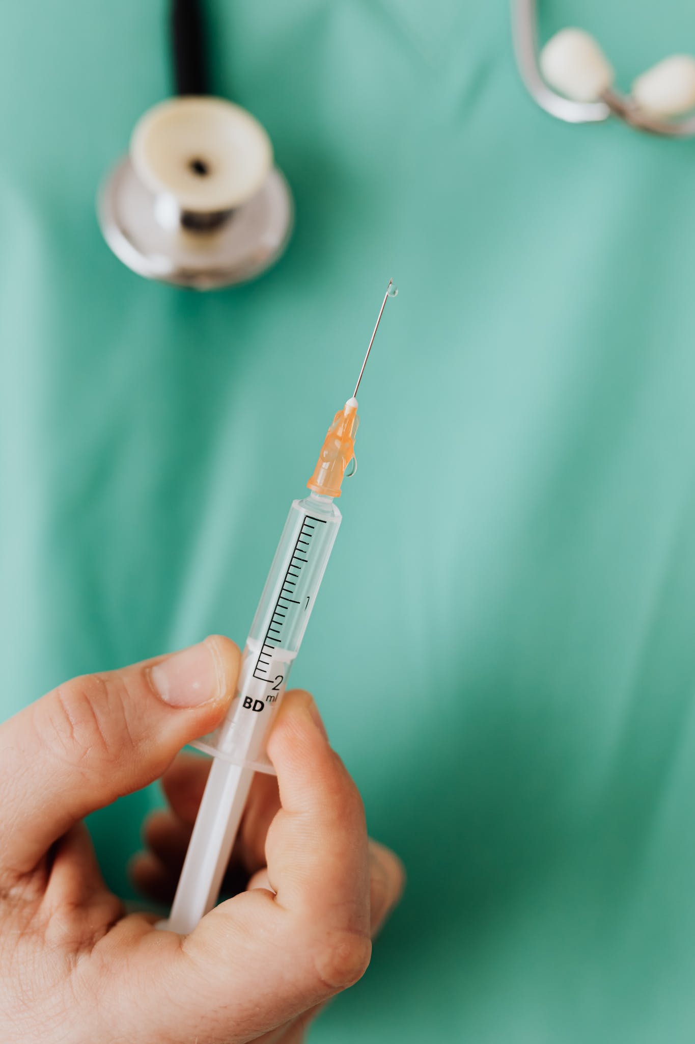 Close-up View Of Person Holding A Vaccine